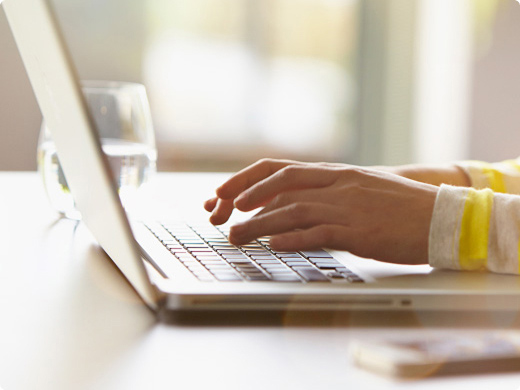 Someone typing on a laptop