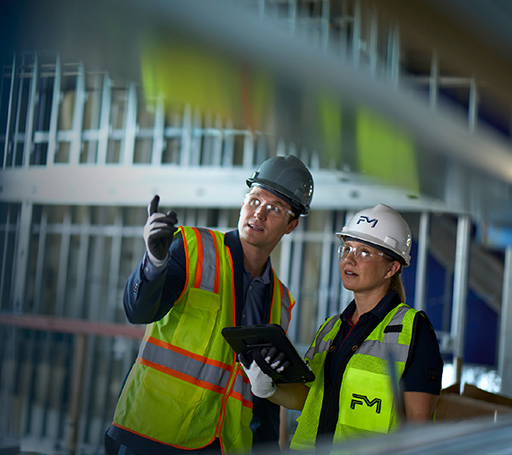 Two FM engineers reviewing a site