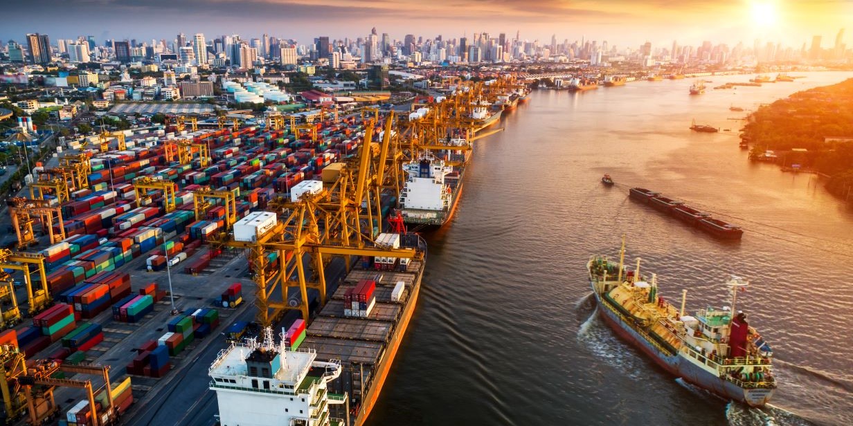An image illustrating logistics in various forms, including rail, truck, cargo, shipping and aviation, against a backdrop of a map