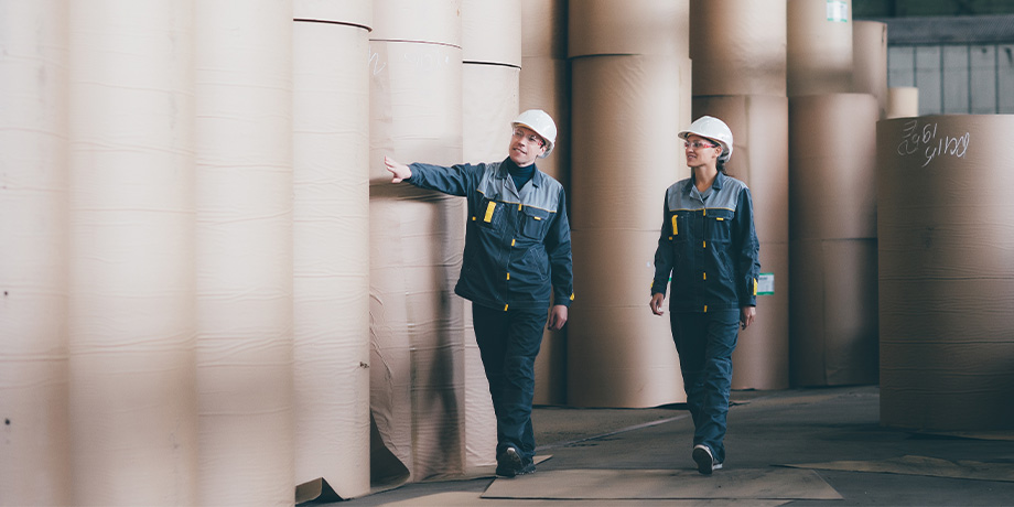 Workers inspecting pulp and paper factory