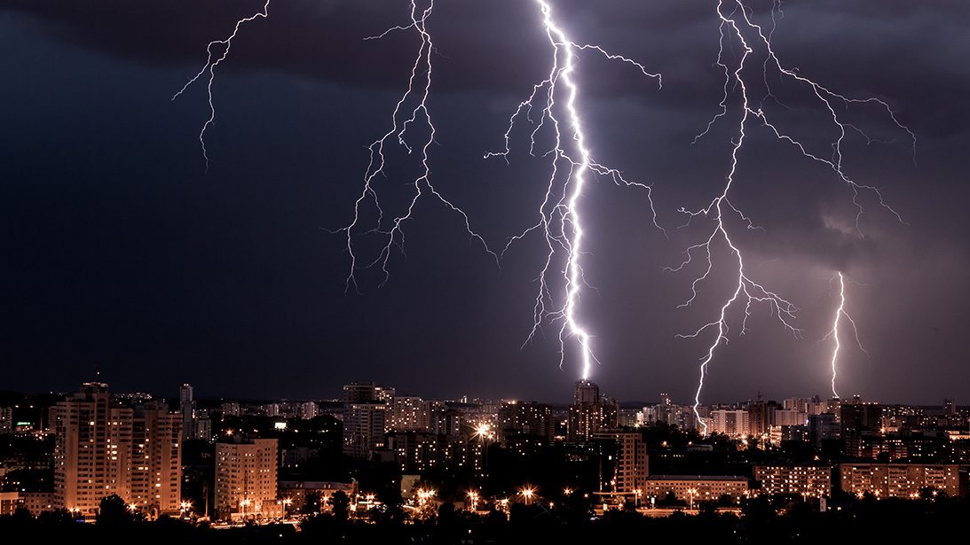 lightning bolts over city skyline