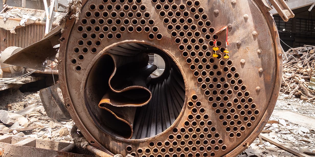 abandoned industrial heat exchanger with rusted boiler tubes and corroded metal