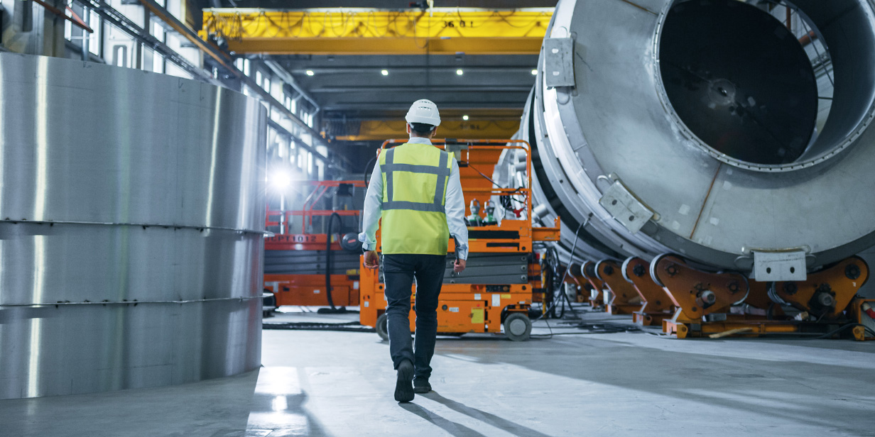 heavy industry engineer walking through factory