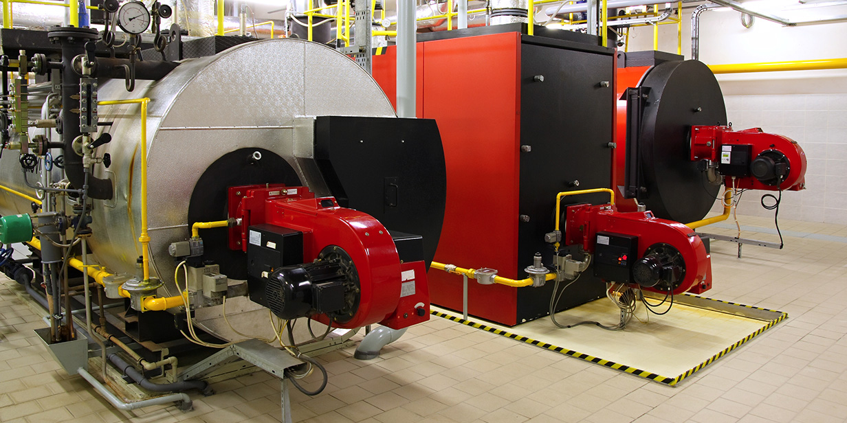 industrial boiler room with large gas-fired heating systems, energy-efficient boilers, and red burner units connected by yellow gas pipes for commercial heating