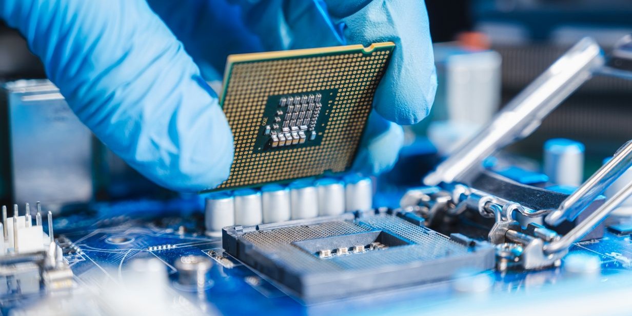 technician installing CPU onto motherboard – close-up of computer hardware assembly for PC build or upgrade