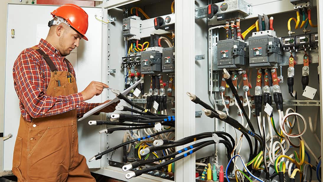 man viewing electrical panel