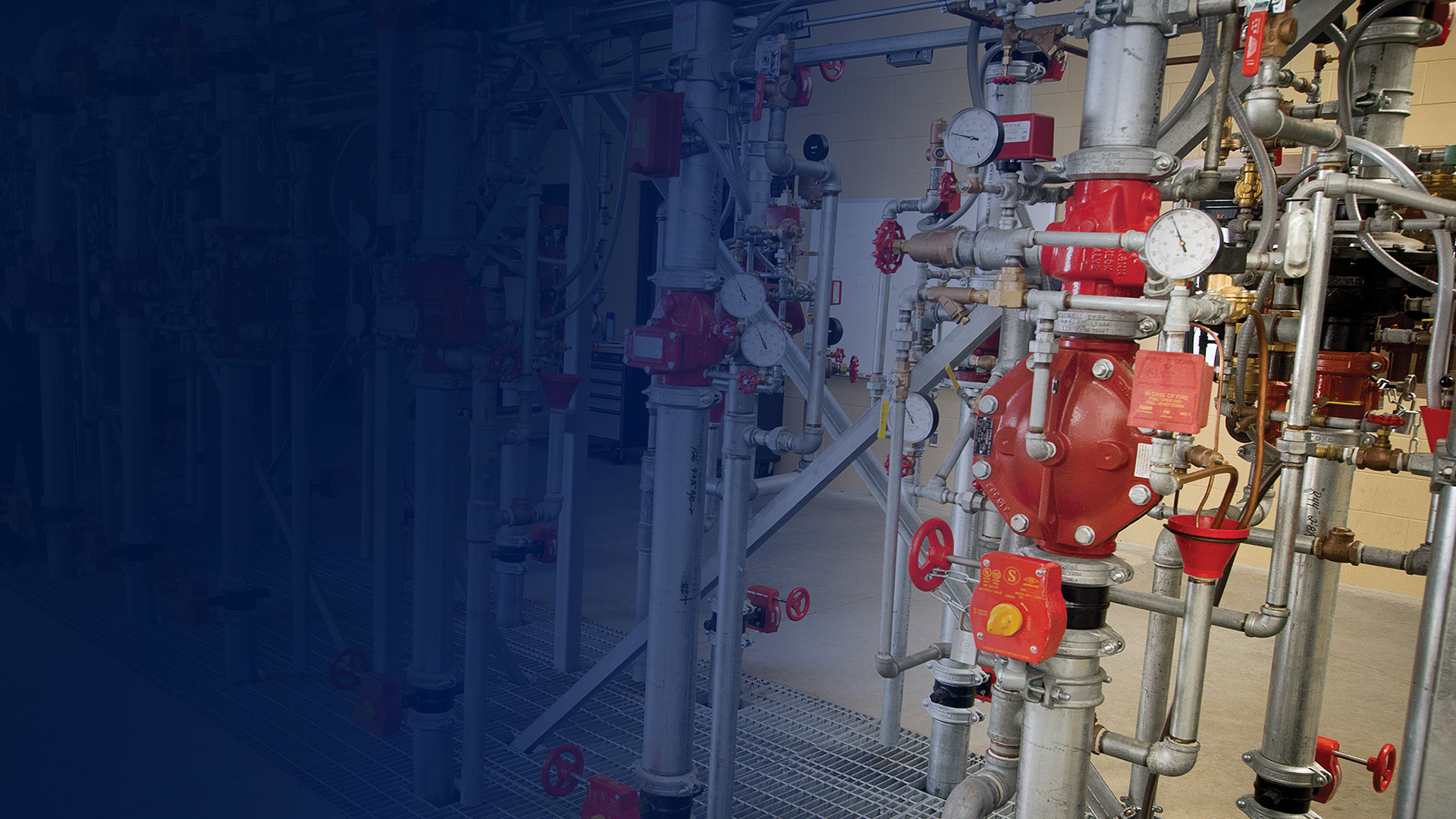 industrial fire protection system with multiple risers, control valves, gauges, and galvanized piping used in fire sprinkler and suppression system installations