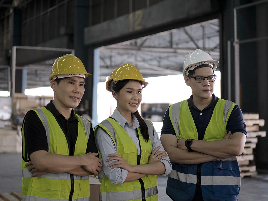 Three workers in a factor